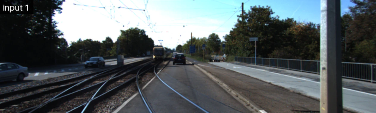 Two consecutive frames from a KITTI driving sequence, alternating